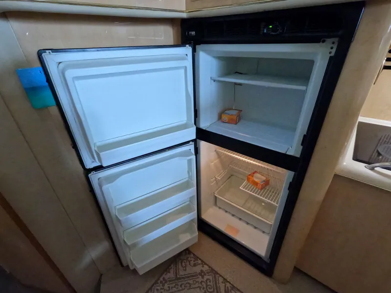 Slide: The Image of Open fridge in 2001 Sea Ray 400 Sedan Bridge yacht kitchen. - 55