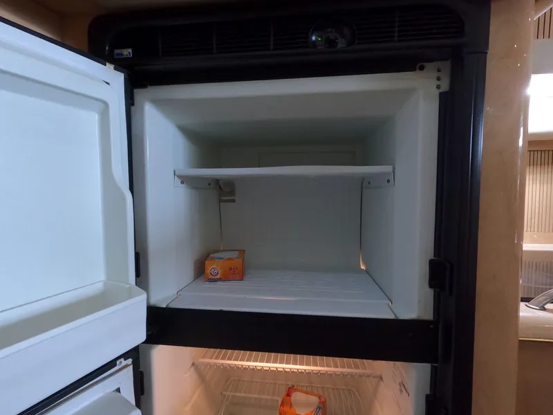Slide: The Image of Open refrigerator in 2001 Sea Ray 400 Sedan Bridge yacht kitchen. - 56