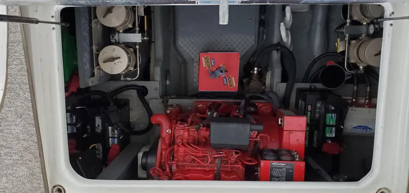 Slide: The Image of Engine compartment of 2001 Sea Ray 400 Sedan Bridge, showcasing red engine and components. - 63