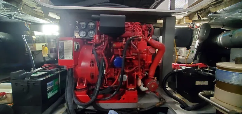 Slide: The Image of Engine room of 2001 Sea Ray 400 Sedan Bridge with red machinery and components. - 66