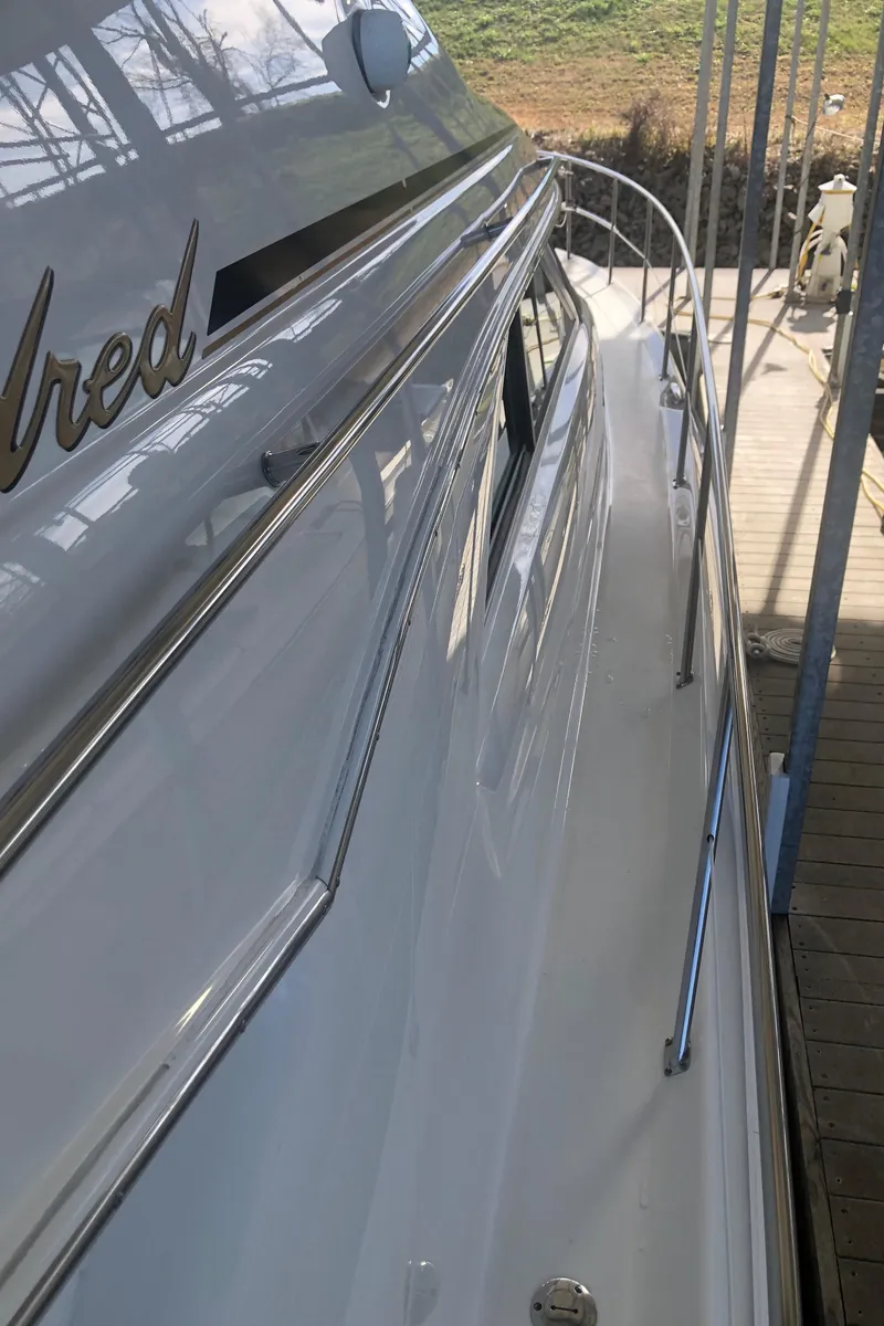 Slide: The Image of 2001 Sea Ray 400 Sedan Bridge yacht, side view with sleek design and docked setting. - 7