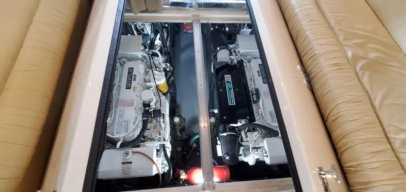 Slide: The Image of Engine compartment of 2001 Sea Ray 400 Sedan Bridge, showcasing dual engines and seating area. - 76