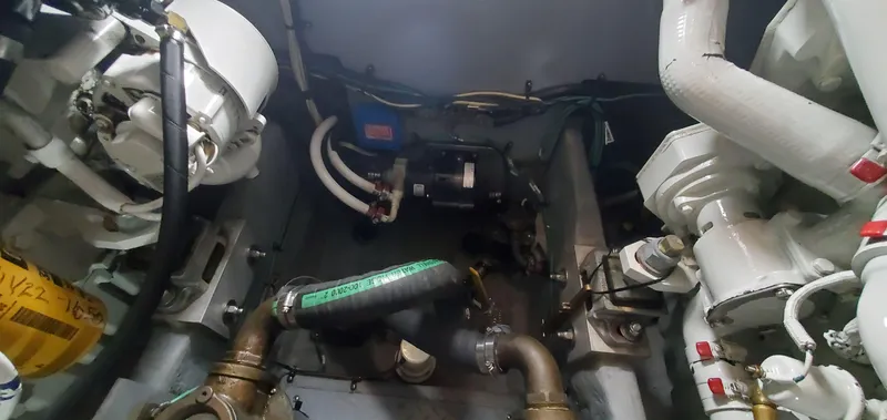 Slide: The Image of Engine room of 2001 Sea Ray 400 Sedan Bridge with visible components and piping. - 79