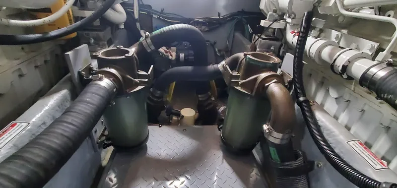 Slide: The Image of Engine room of 2001 Sea Ray 400 Sedan Bridge with visible hoses and components. - 85