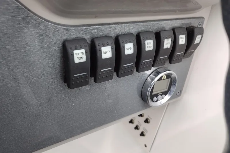 Slide: The Image of Control panel of a 2004 Formula 260 Bowrider boat with labeled switches. - 27
