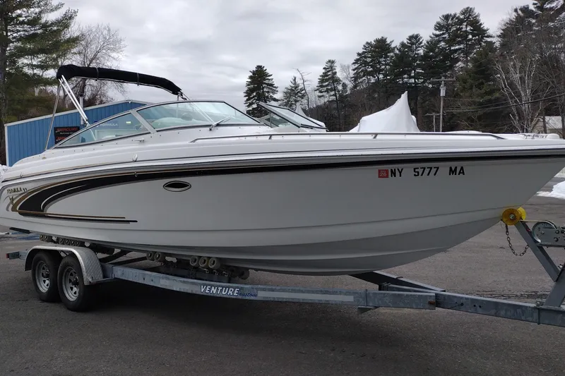 Slide: The Image of 2004 Formula 260 Bowrider boat on trailer, parked outdoors with trees in background. - 3