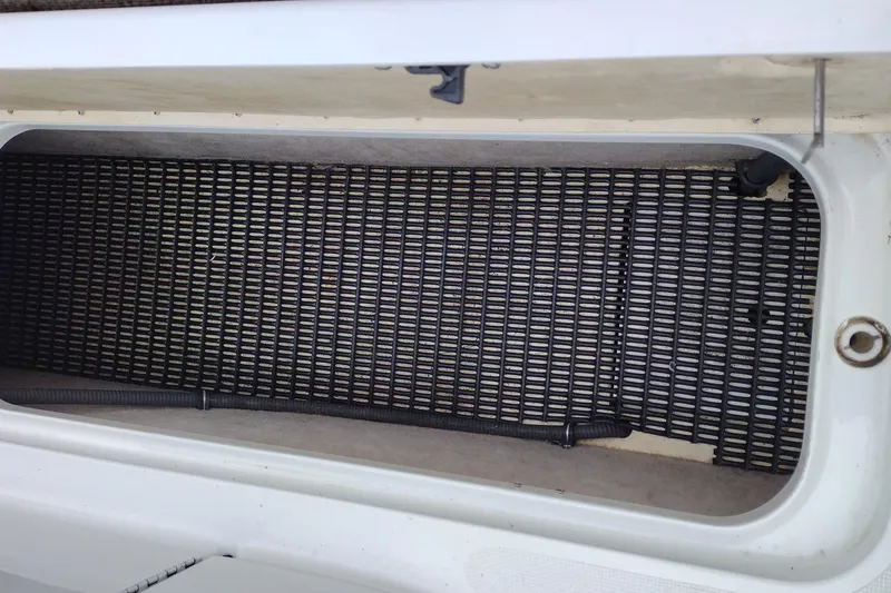 Slide: The Image of Storage compartment of a 2004 Formula 260 Bowrider boat with black grid mat. - 35