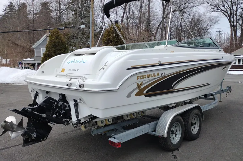 Slide: The Image of 2004 Formula 260 Bowrider boat on trailer, parked outdoors in winter setting. - 5