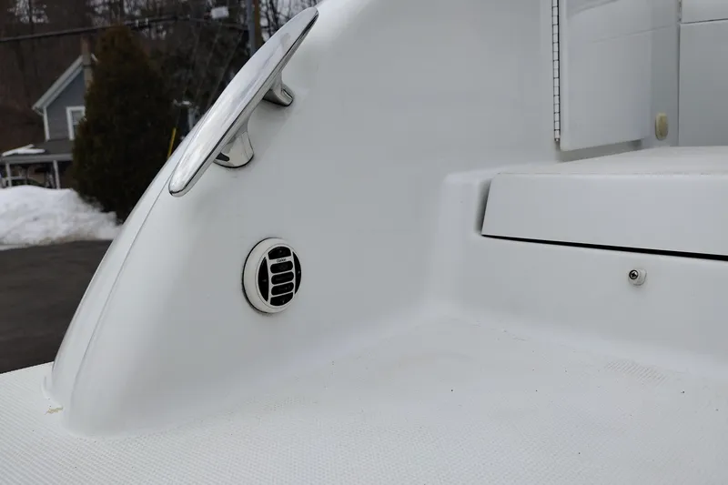 Slide: The Image of 2004 Formula 260 Bowrider boat detail, featuring a cleat and vent on white deck. - 8