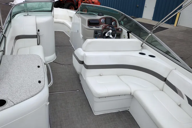 Slide: The Image of 2004 Formula 260 Bowrider interior with white seating and modern dashboard. - 9