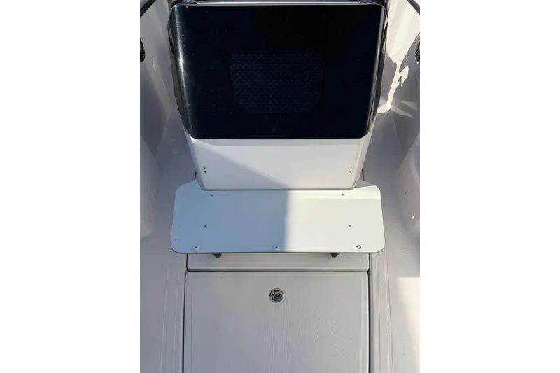 Slide: The Image of 2022 Axopar 22 T-Top boat interior detail with seating and storage compartment. - 11