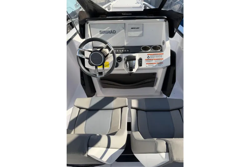 Slide: The Image of 2022 Axopar 22 T-Top boat cockpit with steering wheel and control panel. - 12