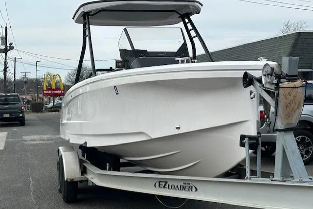 Slide: The Image of 2022 Axopar 22 T-Top boat on EZ Loader trailer in parking lot. - 4
