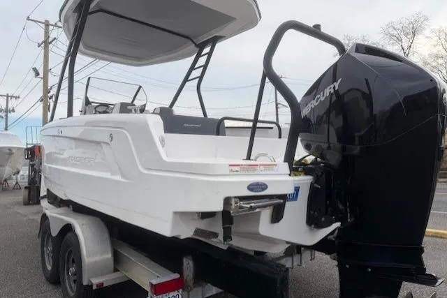 Slide: The Image of 2022 Axopar 22 T-Top boat on trailer with Mercury outboard engine. - 5
