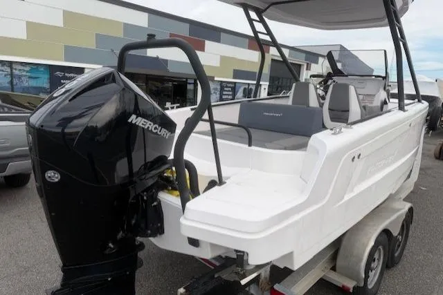 Slide: The Image of 2022 Axopar 22 T-Top boat with Mercury engine on trailer, outdoor display. - 6