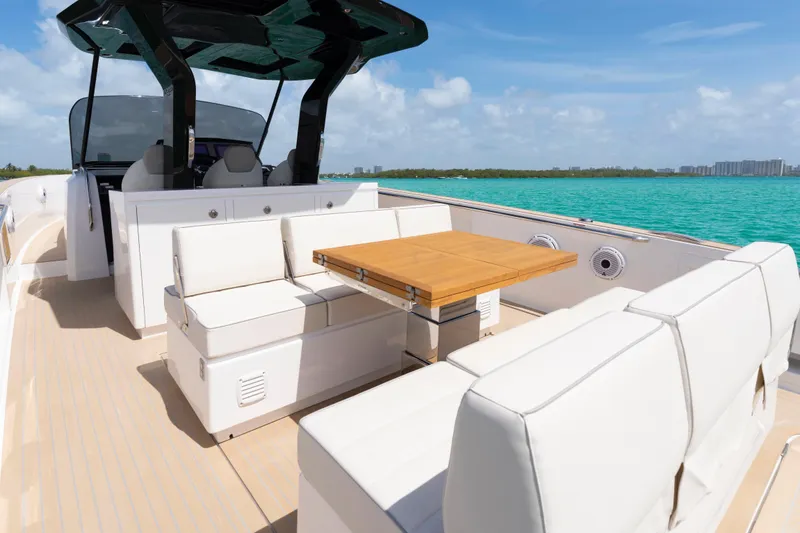 Slide: The Image of 2025 Pardo Yachts P38 with elegant seating and table on turquoise waters. - 15