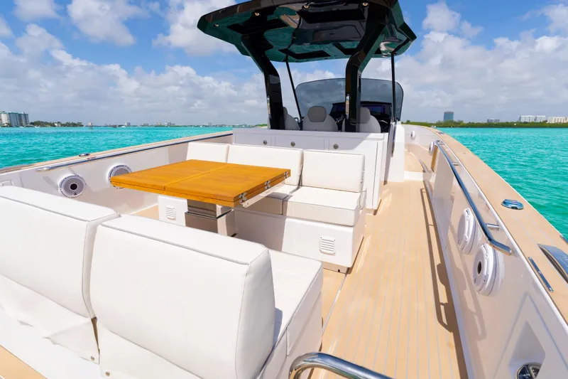 Slide: The Image of 2025 Pardo Yachts P38 luxury yacht interior with seating and table on turquoise water. - 17