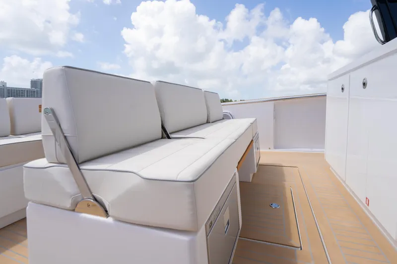 Slide: The Image of Luxury seating on the deck of a 2025 Pardo Yachts P38, under a bright sky. - 21