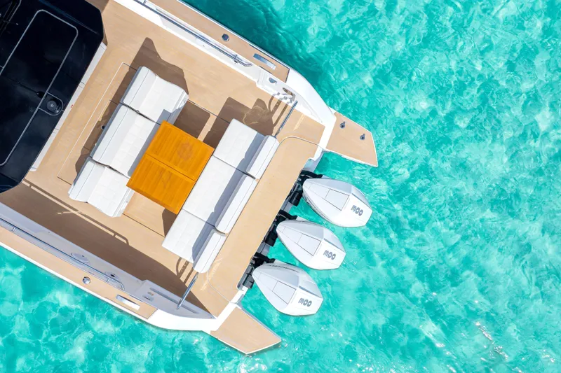 Slide: The Image of Aerial view of 2025 Pardo Yachts P38 on turquoise water, featuring sleek deck and triple engines. - 4