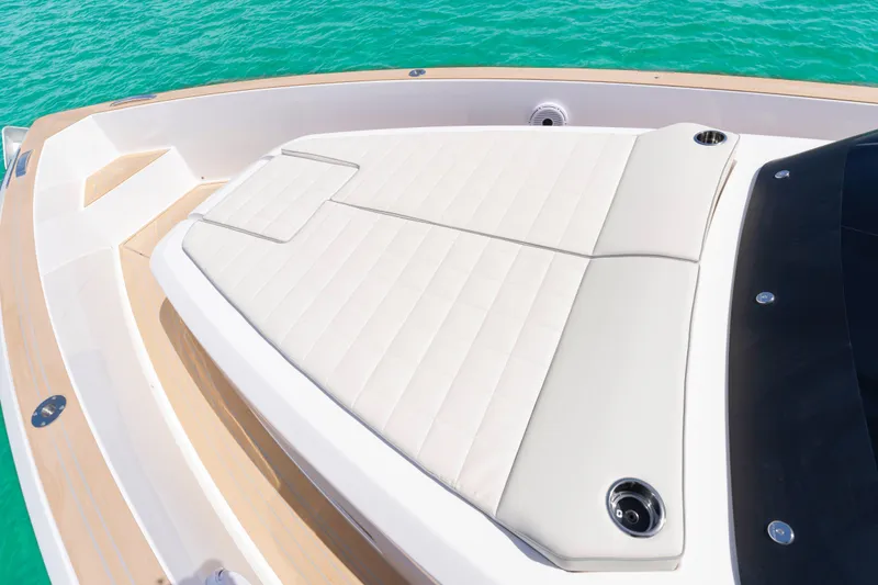 Slide: The Image of 2025 Pardo Yachts P38 deck with cushioned seating, surrounded by turquoise water. - 41