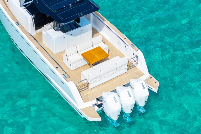 Slide: The Image of 2025 Pardo Yachts P38 on turquoise water, featuring sleek design and triple outboard engines. - 5