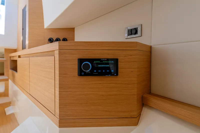 Slide: The Image of Interior of 2025 Pardo Yachts P38 featuring modern wooden cabinetry and audio system. - 50
