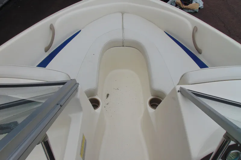 Slide: The Image of 2004 Bayliner 1750 Capri boat interior with white seating and blue accents. - 11