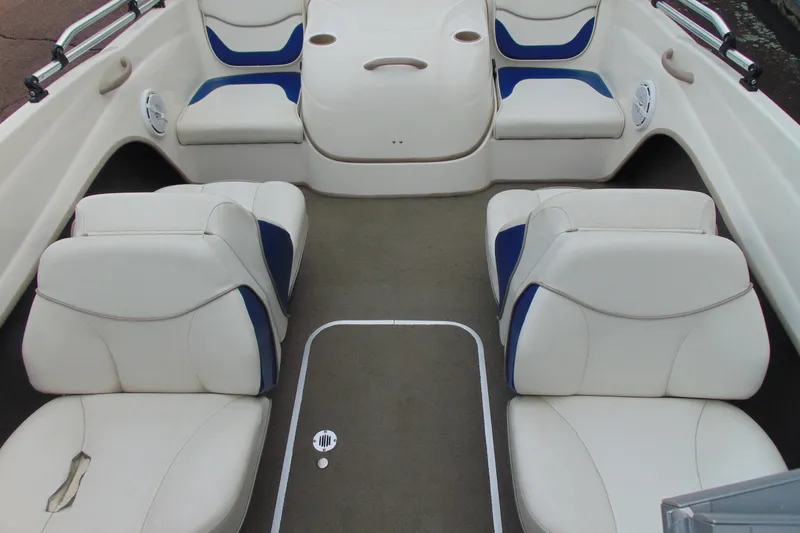 Slide: The Image of 2004 Bayliner 1750 Capri boat interior with white and blue seating arrangement. - 12
