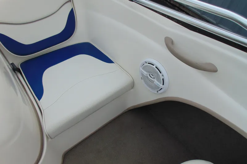 Slide: The Image of 2004 Bayliner 1750 Capri interior with blue and white seating and speaker detail. - 13