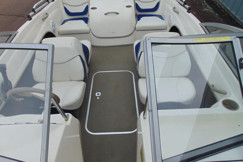 Slide: The Image of 2004 Bayliner 1750 Capri interior with white and blue seating, open cockpit view. - 16