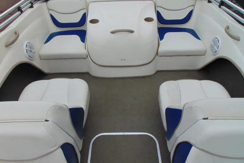 Slide: The Image of 2004 Bayliner 1750 Capri boat interior with white and blue seating arrangement. - 17