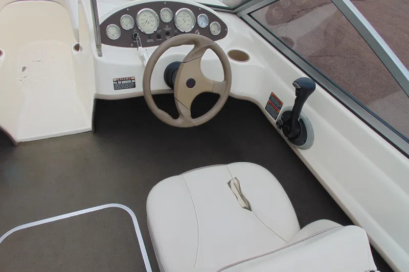 Slide: The Image of 2004 Bayliner 1750 Capri boat interior with steering wheel and dashboard controls. - 8