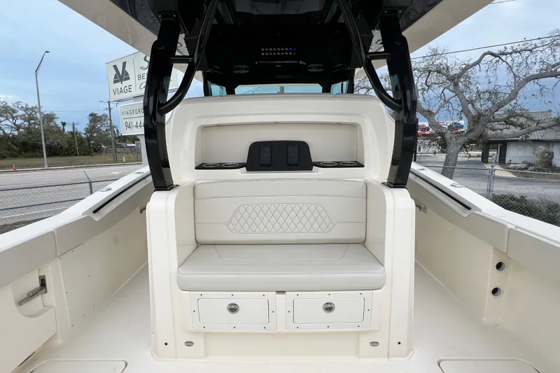 Slide: The Image of 2026 Scout 377 LXF boat interior with cushioned seating and storage compartments. - 12