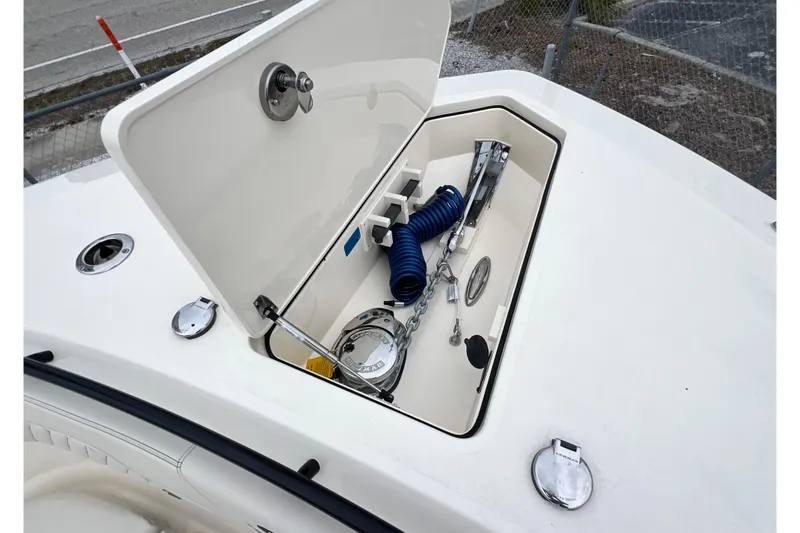 Slide: The Image of 2026 Scout 377 LXF boat storage compartment with anchor and coiled hose. - 15