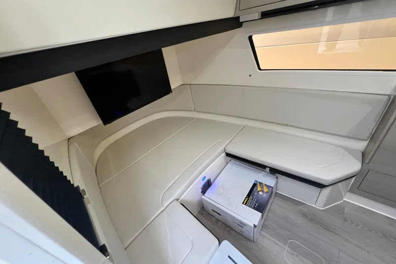Slide: The Image of Interior of 2026 Scout 377 LXF boat with seating, TV, and modern design. - 17