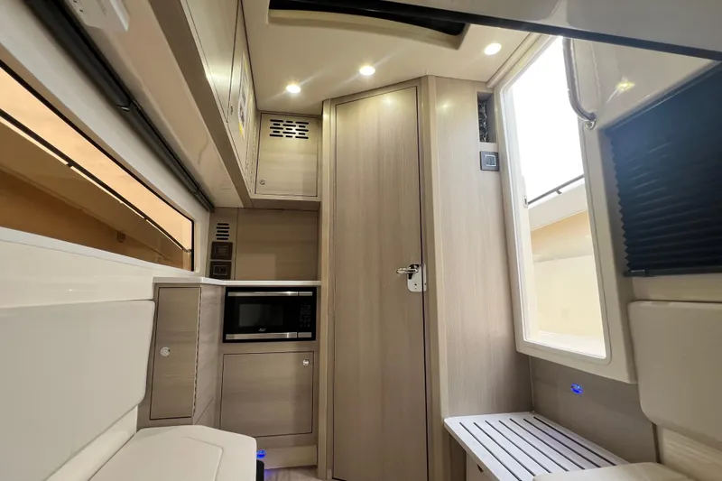 Slide: The Image of Interior of 2026 Scout 377 LXF boat with modern cabinetry and microwave. - 22