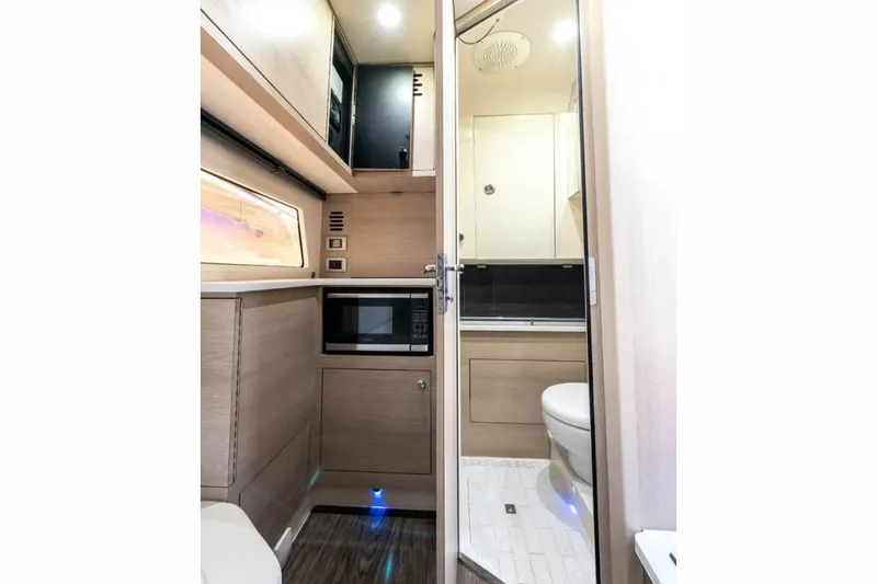 Slide: The Image of Manufacturer Provided Image: 2025 Scout 377 LXF interior with modern kitchenette and compact bathroom. - 23