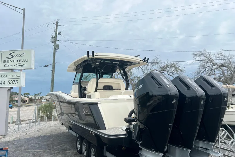 Slide: The Image of 2026 Scout 377 LXF boat with triple Mercury engines on a trailer. - 3