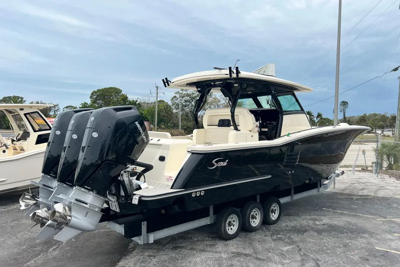 Slide: The Image of 2026 Scout 377 LXF boat with triple Mercury engines on a trailer. - 5
