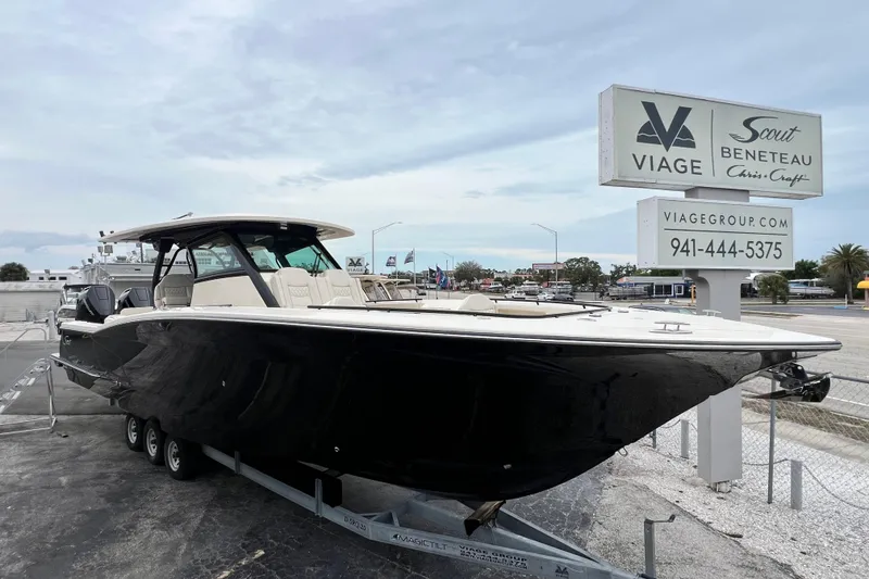 Slide: The Image of 2026 Scout 377 LXF boat displayed at Viage dealership, featuring sleek black design. - 7