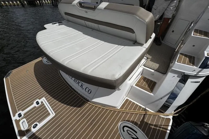 Slide: The Image of 2018 Regal 35 Sport Coupe boat with cushioned seating and teak-style deck. - 11
