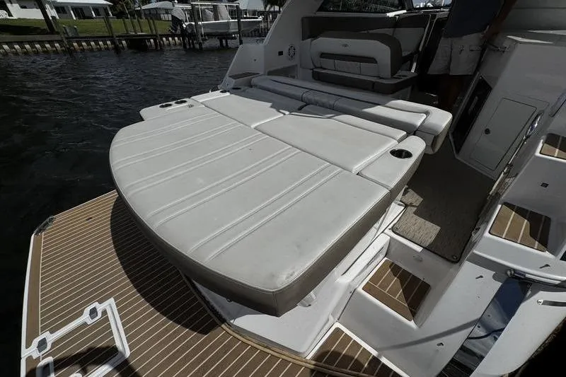 Slide: The Image of 2018 Regal 35 Sport Coupe boat with spacious rear seating and deck area. - 16