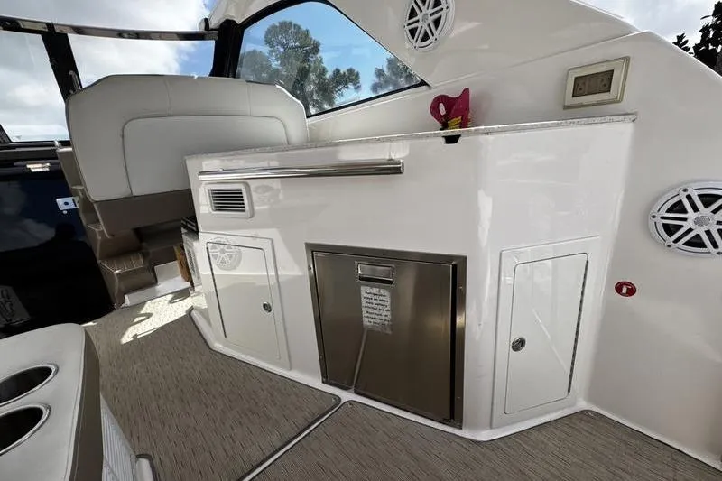 Slide: The Image of Interior of 2018 Regal 35 Sport Coupe boat with kitchenette and seating area. - 18