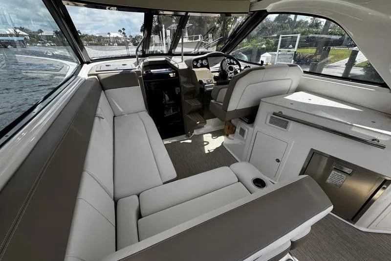 Slide: The Image of 2018 Regal 35 Sport Coupe interior with plush seating and modern helm. - 20
