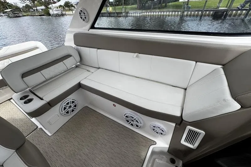 Slide: The Image of 2018 Regal 35 Sport Coupe interior with beige seating and waterfront view. - 21