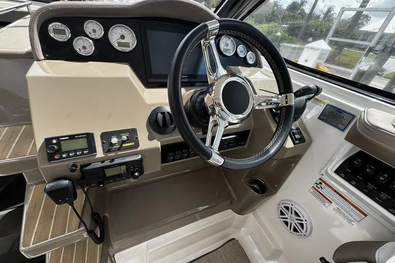Slide: The Image of 2018 Regal 35 Sport Coupe helm with steering wheel and control panel. - 27