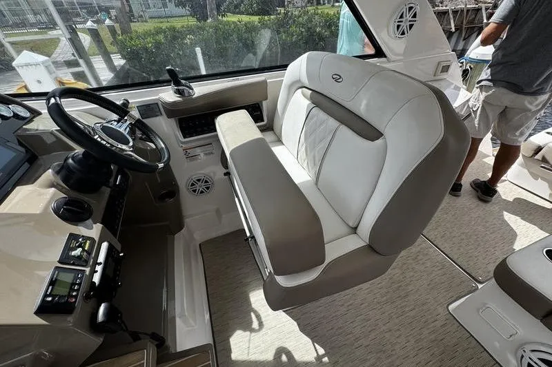 Slide: The Image of Interior of 2018 Regal 35 Sport Coupe boat with steering wheel and seating. - 29