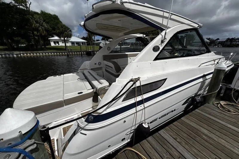 Slide: The Image of 2018 Regal 35 Sport Coupe docked by a wooden pier under cloudy skies. - 3