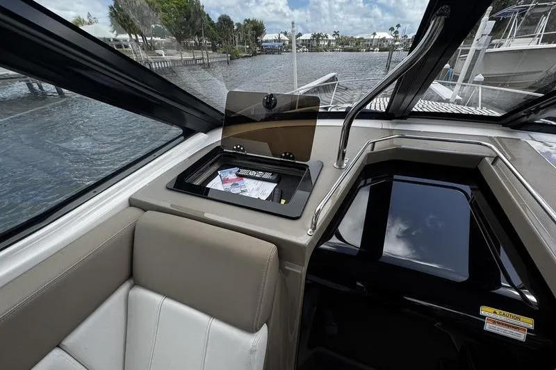 Slide: The Image of Interior of 2018 Regal 35 Sport Coupe with open storage compartment and water view. - 31