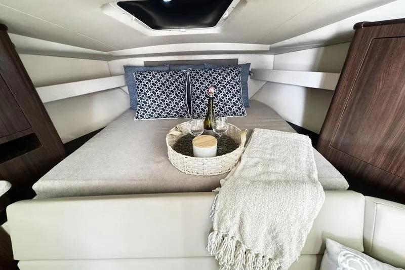 Slide: The Image of Luxurious cabin interior of 2018 Regal 35 Sport Coupe with cozy bedding and decor. - 35